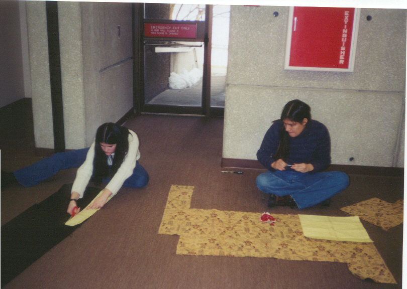 Jelena and Sarah cutting material for the tote bags